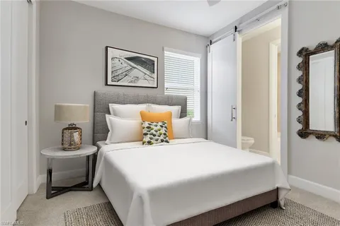 a bedroom with a bed and a painting on the wall