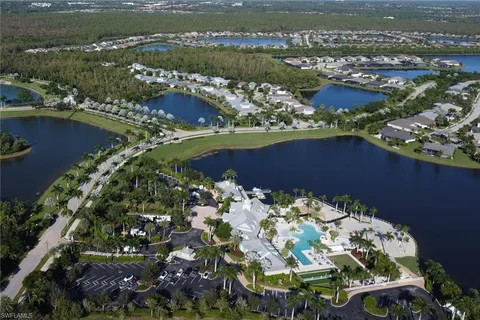 an aerial view of lake and residential houses with outdoor space