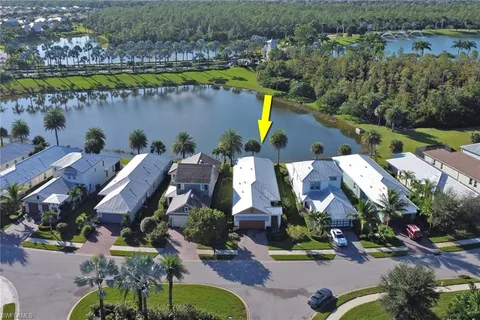 an aerial view of a house with a garden and lake view