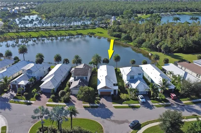 an aerial view of a house with a garden and lake view