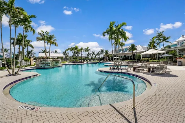 a view of a swimming pool with a table and chairs