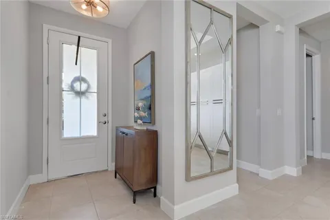 a view of an entryway with wooden floor and mirror