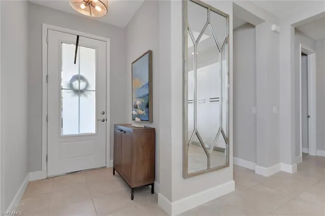 a view of an entryway with wooden floor and mirror