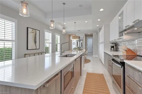 a large kitchen with stainless steel appliances lots of counter space and wooden floor