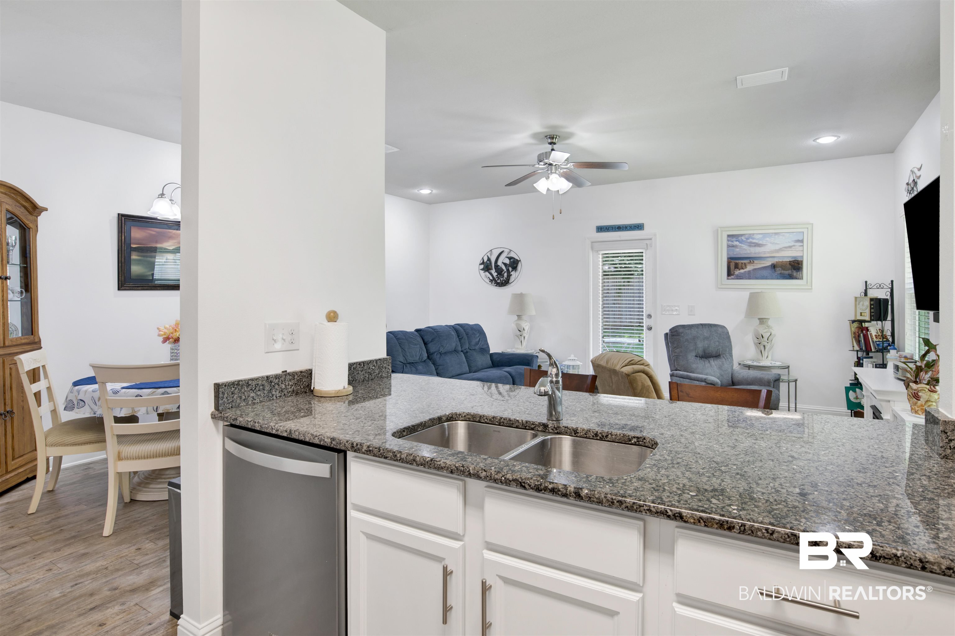 25806 Pollard Road, Unit 20 Daphne, AL 36526 - Photo 5 of 29 Kitchen featuring light hardwood / wood-style flooring, white cabinets, ceiling fan, stainless steel dishwasher, and sink