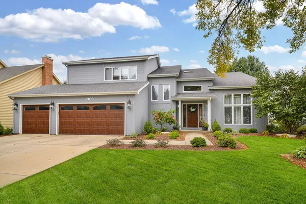 a front view of a house with a yard and garage
