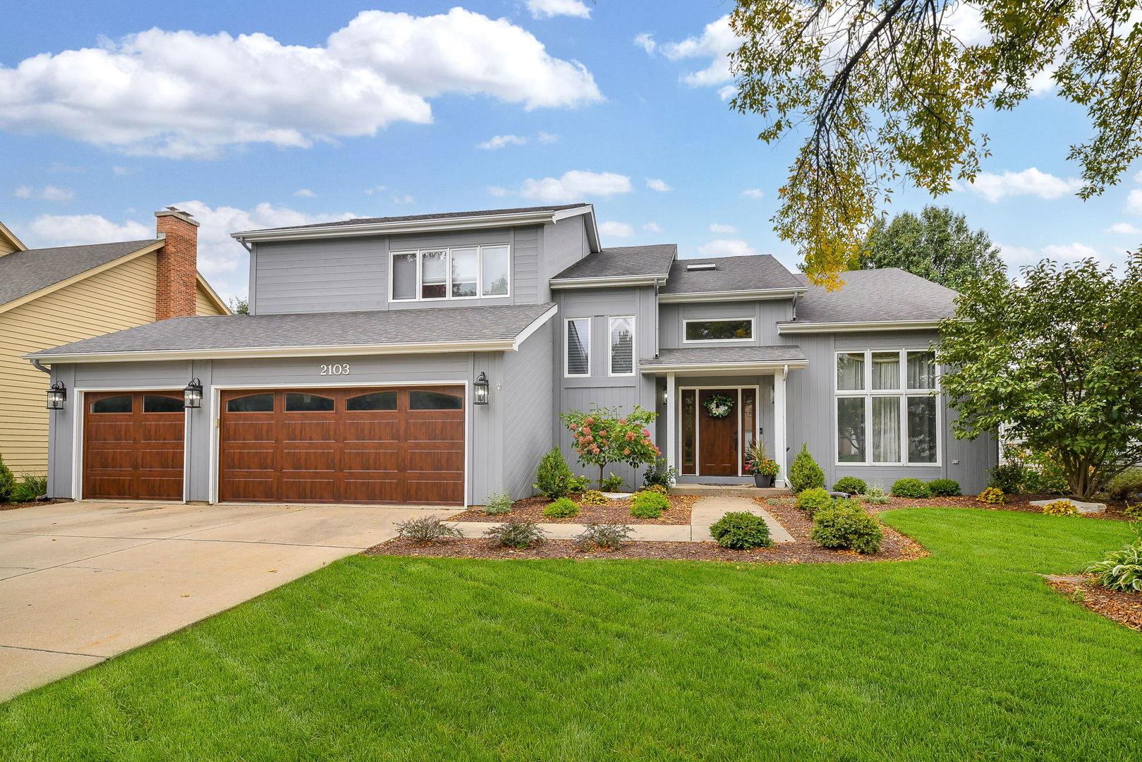 a front view of a house with a yard and garage