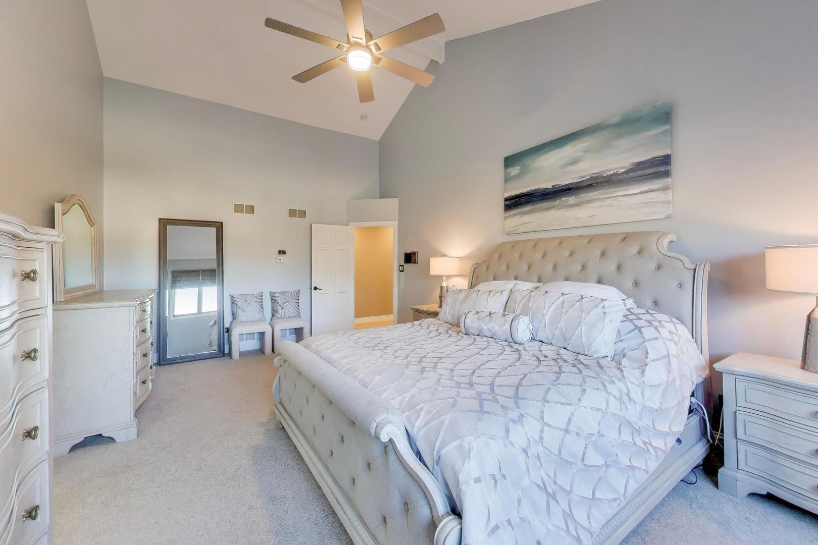 2103 Primrose Lane Naperville, IL 60565 - Photo 16 of 40 a spacious bedroom with a bed and a chandelier