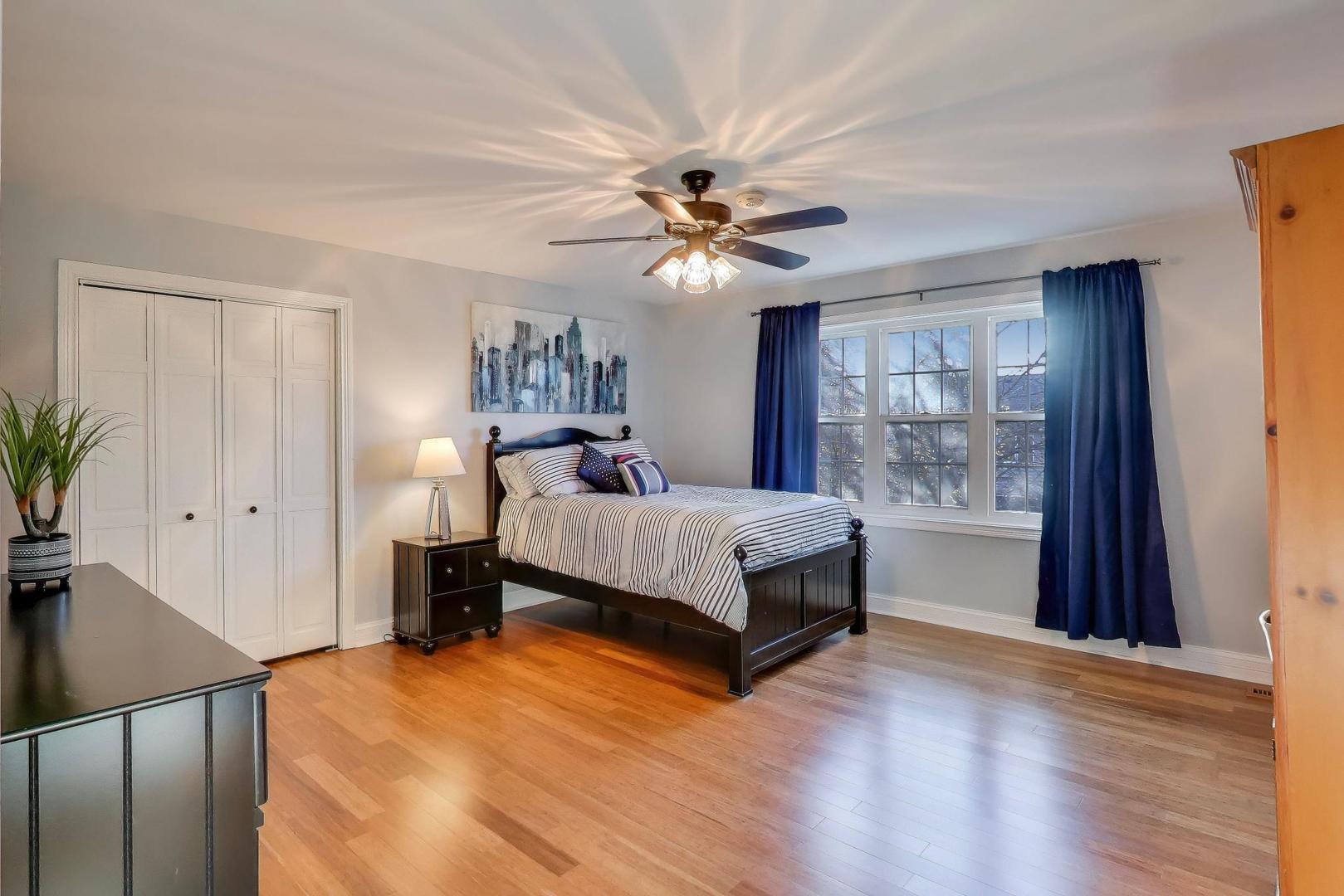 2103 Primrose Lane Naperville, IL 60565 - Photo 20 of 40 a bedroom with a bed and a chandelier