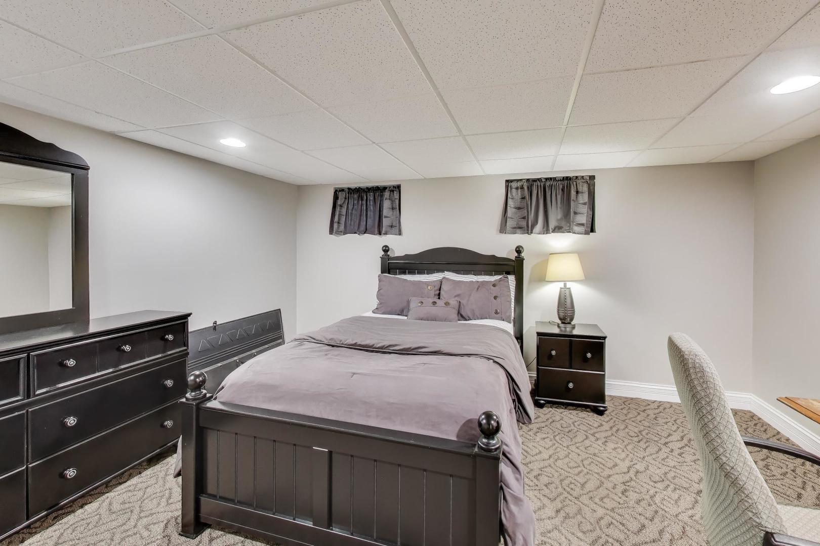 2103 Primrose Lane Naperville, IL 60565 - Photo 27 of 40 a bedroom with a bed and a television