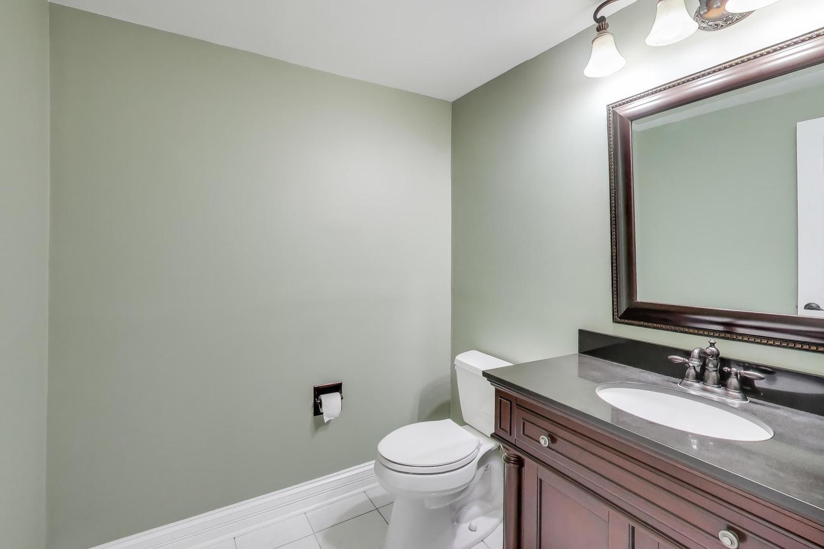 2103 Primrose Lane Naperville, IL 60565 - Photo 28 of 40 a bathroom with a granite countertop toilet and a sink