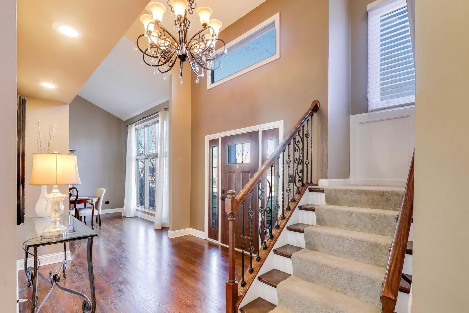 2103 Primrose Lane Naperville, IL 60565 - Photo 4 of 40 a view of a livingroom with furniture stairs and a chandelier fan
