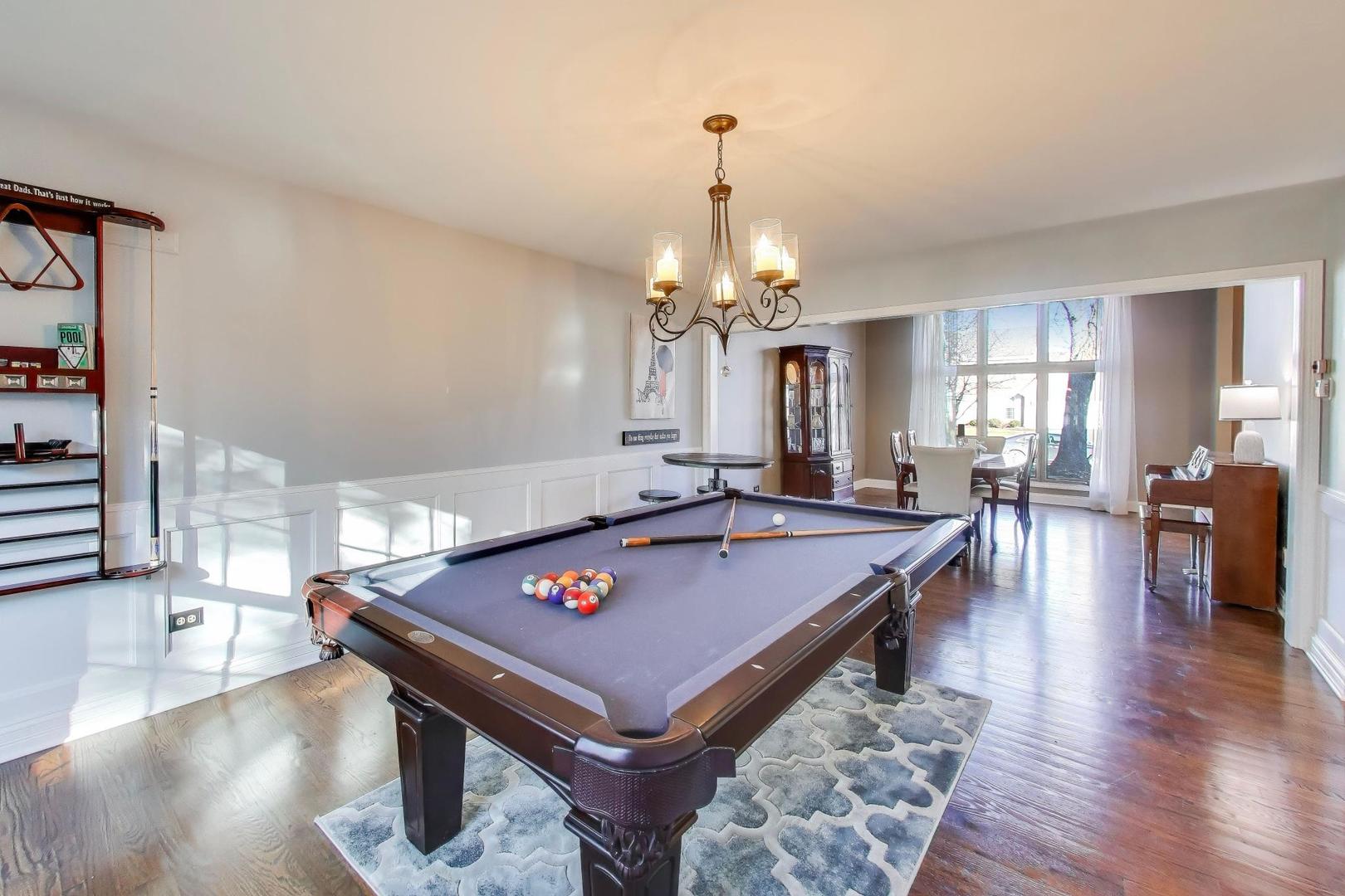 2103 Primrose Lane Naperville, IL 60565 - Photo 6 of 40 a room with pool table and wooden floor