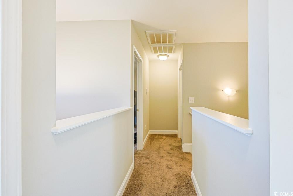 724 Hobonny Loop Longs, SC 29568 - Photo 29 of 40 Hallway with light carpet and baseboards