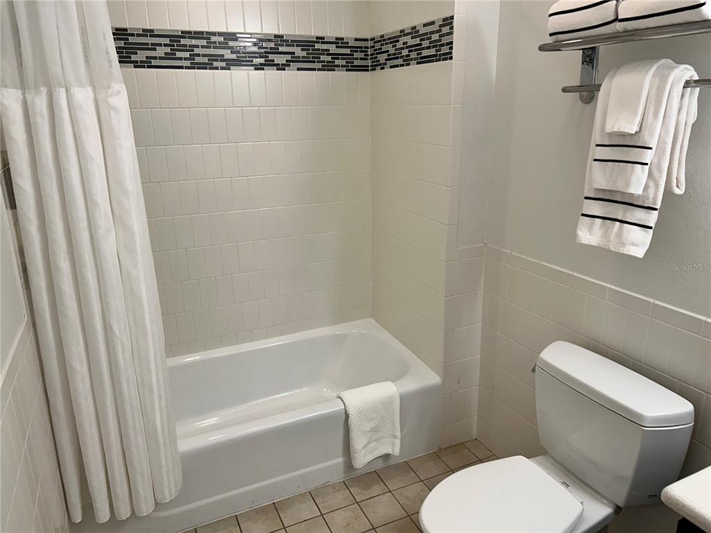 225 Celebration Place, Unit 446 Kissimmee, FL 34747 - Photo 14 of 17 a bathroom with a toilet and a bathtub