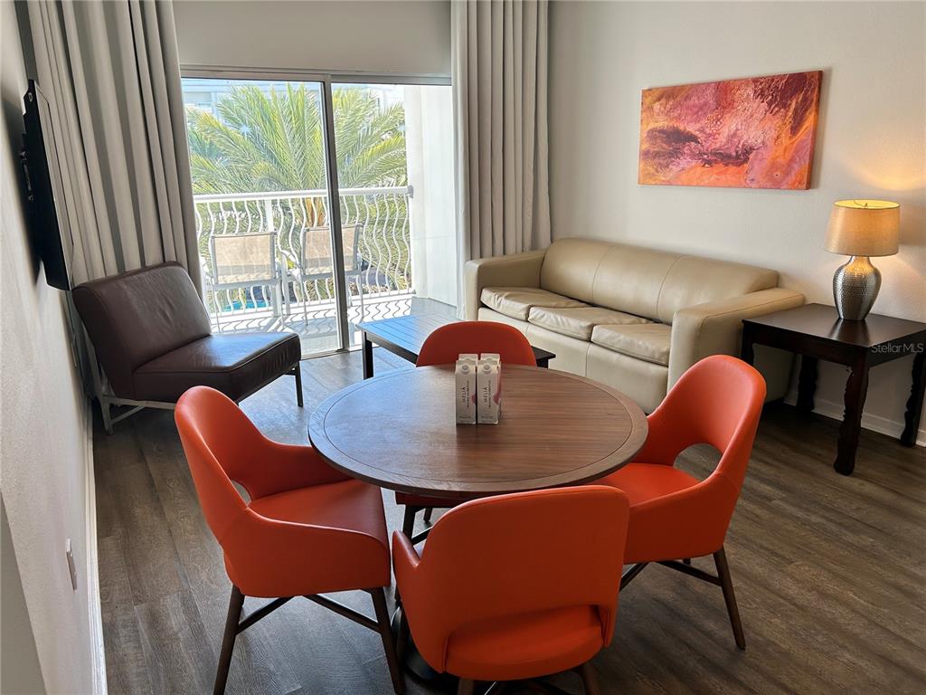 225 Celebration Place, Unit 446 Kissimmee, FL 34747 - Photo 2 of 17 a dining room with furniture a large window and wooden floor
