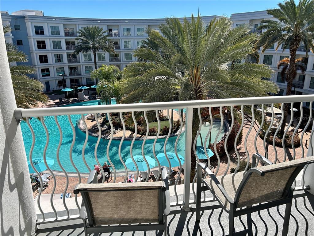 225 Celebration Place, Unit 446 Kissimmee, FL 34747 - Photo 4 of 17 a view of a chairs and table in patio
