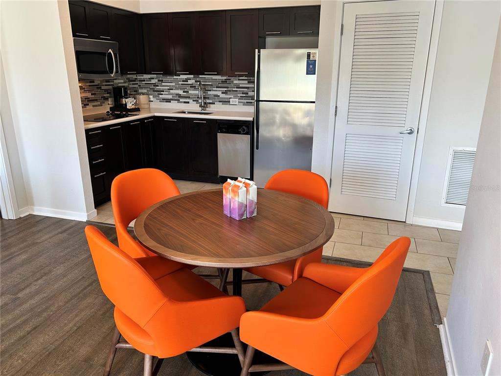 225 Celebration Place, Unit 446 Kissimmee, FL 34747 - Photo 5 of 17 a dining room with furniture and wooden floor