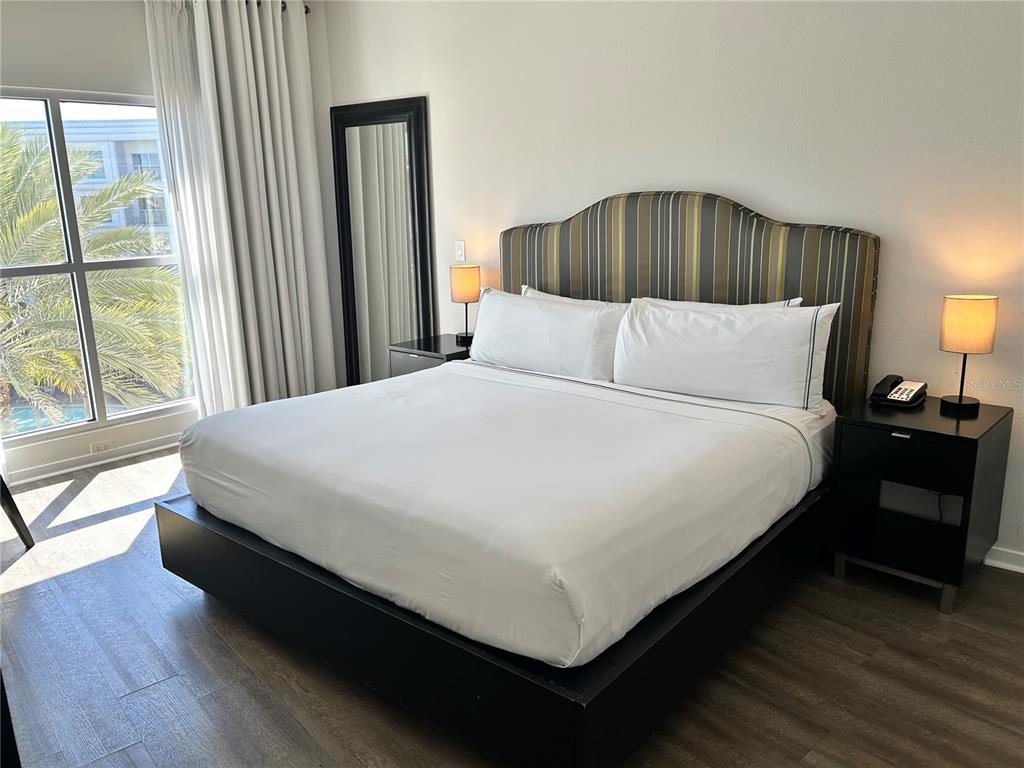 225 Celebration Place, Unit 446 Kissimmee, FL 34747 - Photo 6 of 17 a large bed sitting in a bedroom next to a window