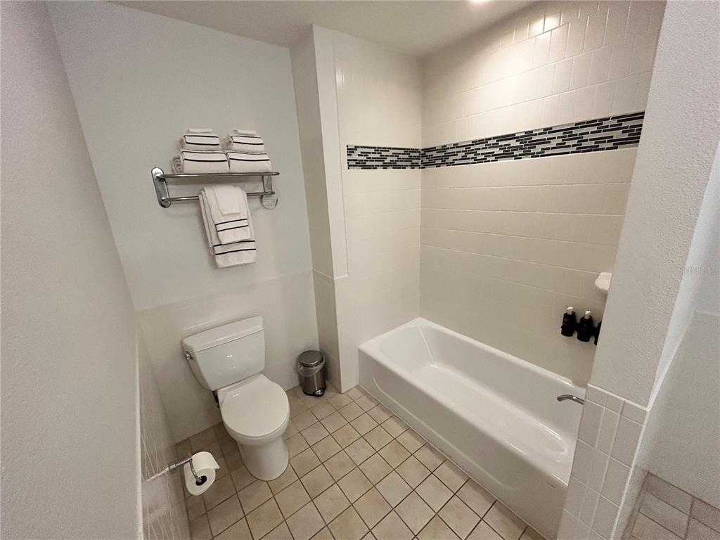 225 Celebration Place, Unit 446 Kissimmee, FL 34747 - Photo 8 of 17 a bathroom with a toilet and a shower