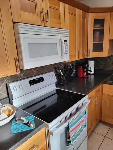 a kitchen with an oven a stove and a microwave