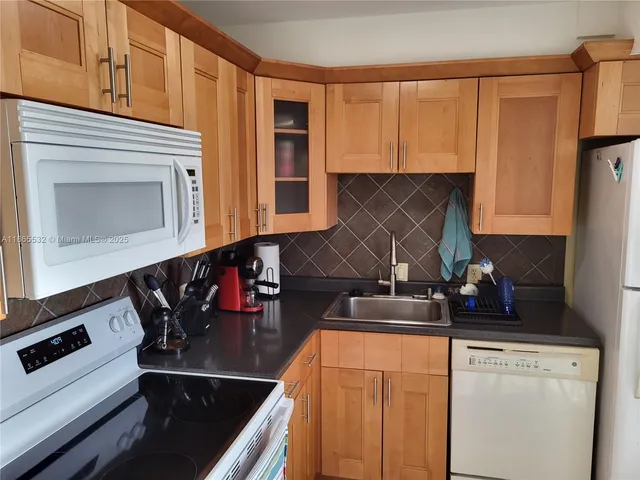 a kitchen with stainless steel appliances granite countertop a stove and a microwave