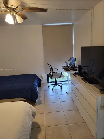 a room with a chair and a potted plant