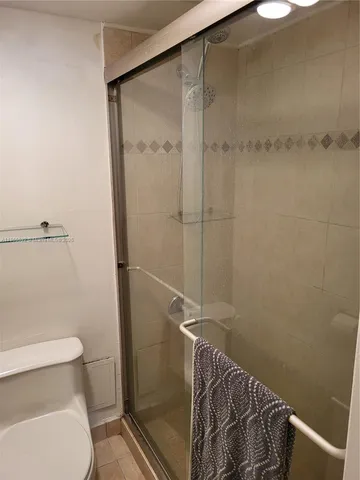 a bathroom with a shower and a toilet