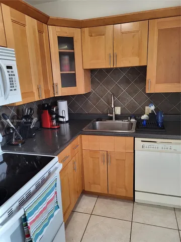 a kitchen with stainless steel appliances granite countertop a sink and a microwave