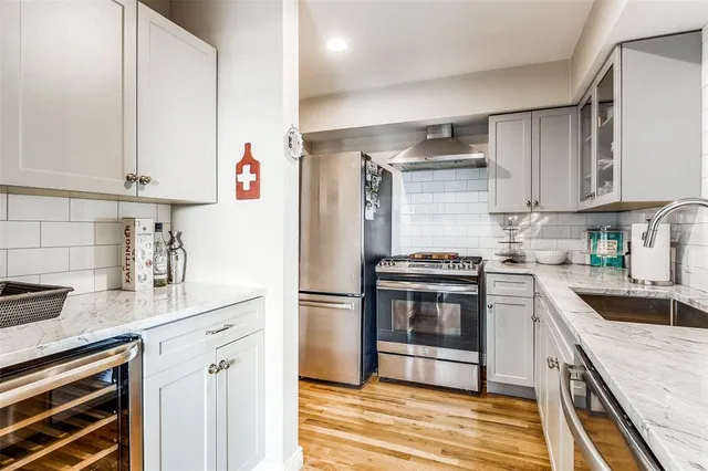 a kitchen with a sink cabinets and stainless steel appliances