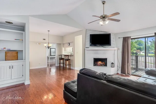 a living room with furniture fireplace and flat screen tv