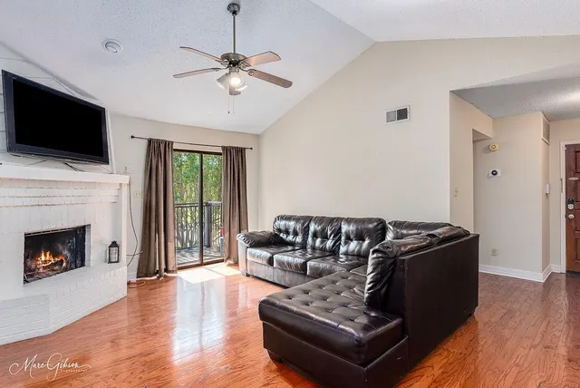 a living room with furniture fireplace and flat screen tv