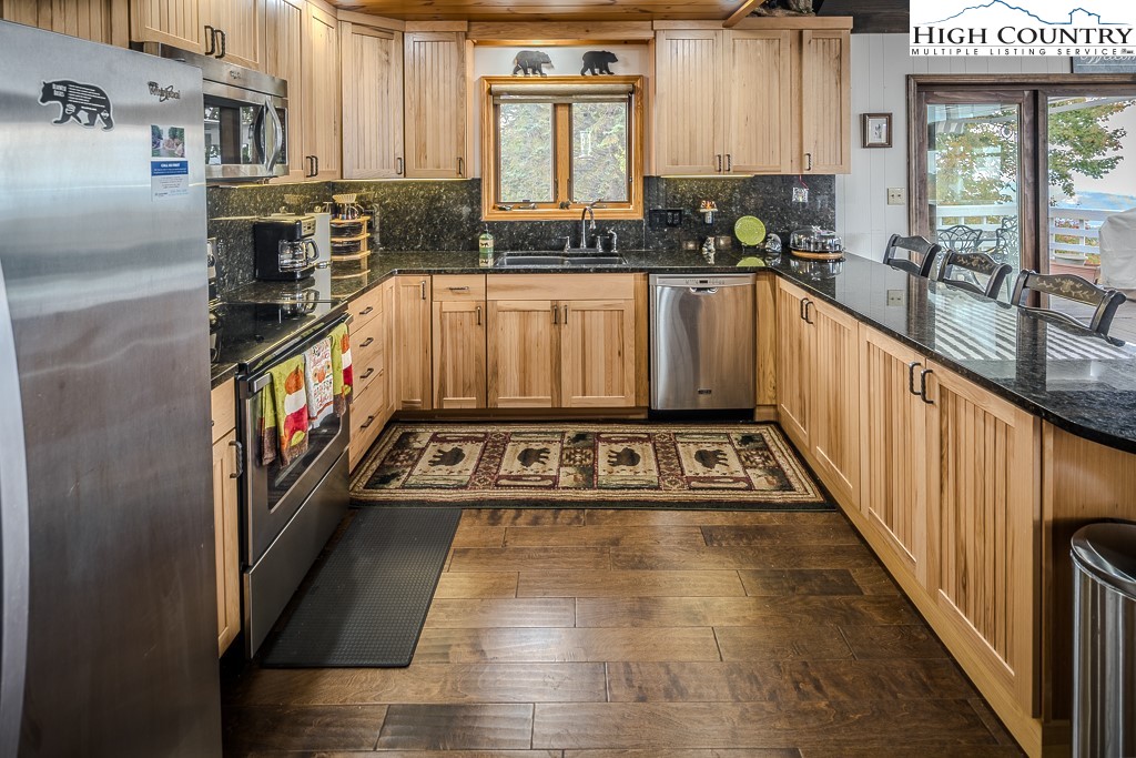 206 Pinnacle Ridge Road Beech Mountain, NC 28604 - Photo 9 of 41 a view of a kitchen with stainless steel appliances granite countertop a stove a sink and a refrigerator