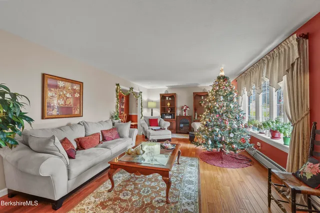 a view of a dining room with furniture a chandelier and wooden floor