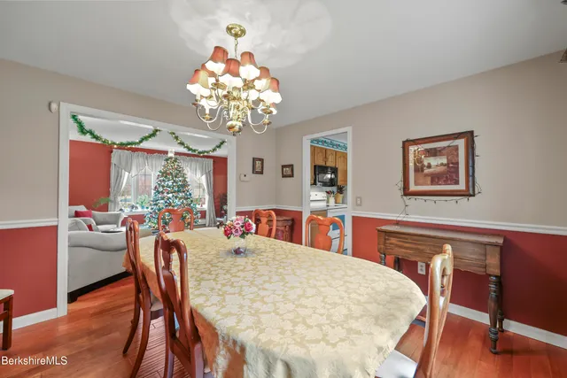 a dining area with a table chairs and a kitchen view