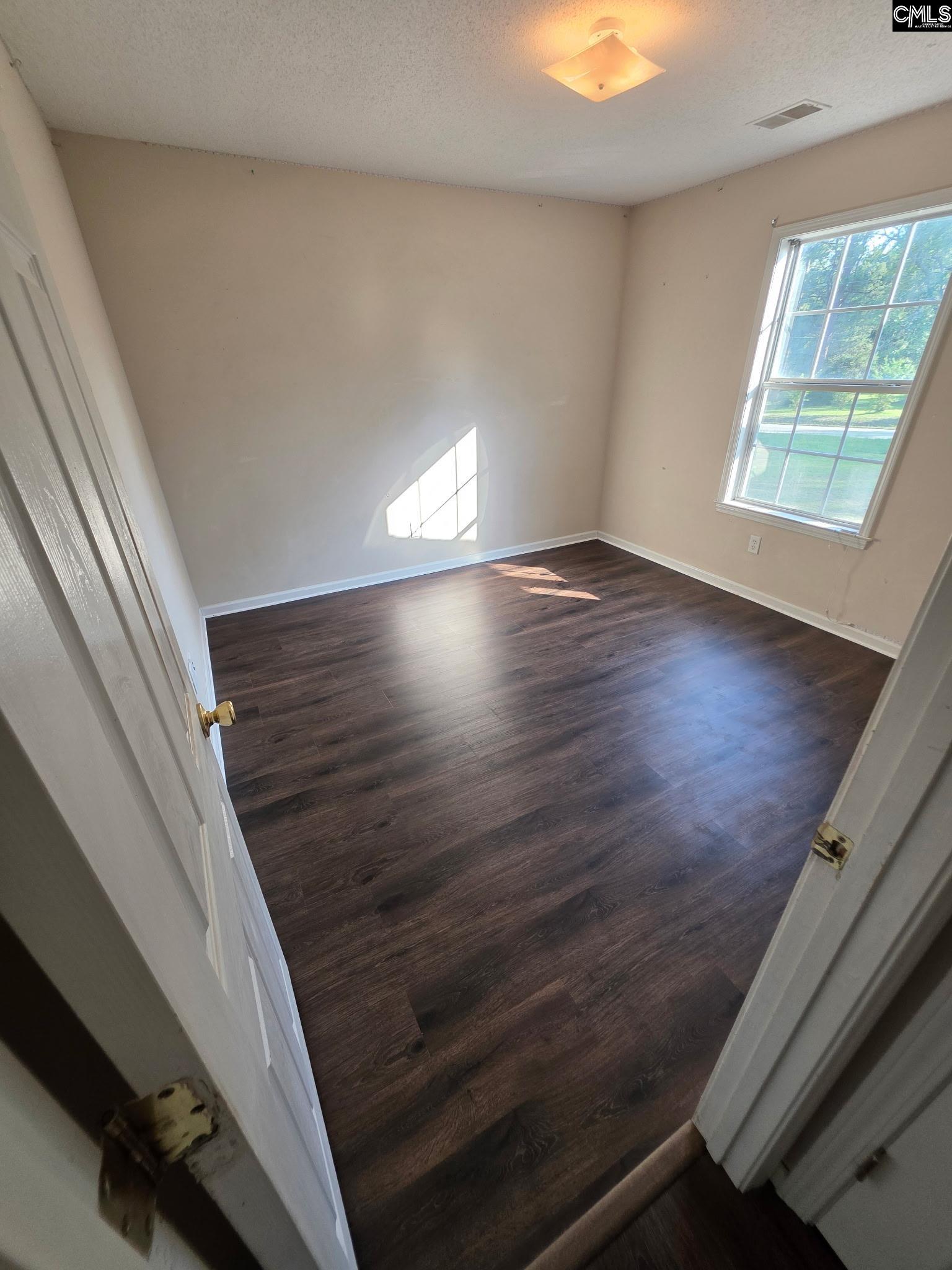 900 Watts Hill Road Lugoff, SC 29078 - Photo 19 of 33 wooden floor in an empty room with a window