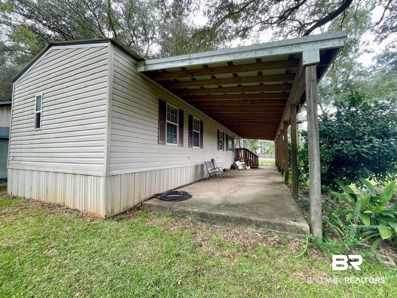 15338 Windbigler Drive Foley, AL 36535 - Photo 4 of 28 View of property exterior with a lawn and a patio area
