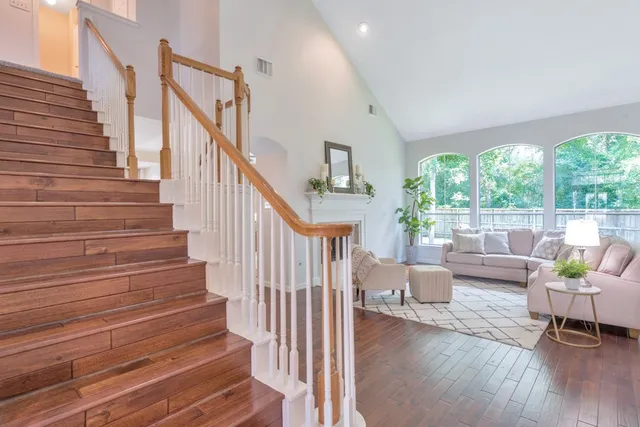a view of a hallway with wooden floor and entryway