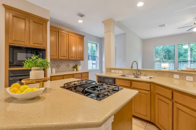 a front view of a house with a garden and plants