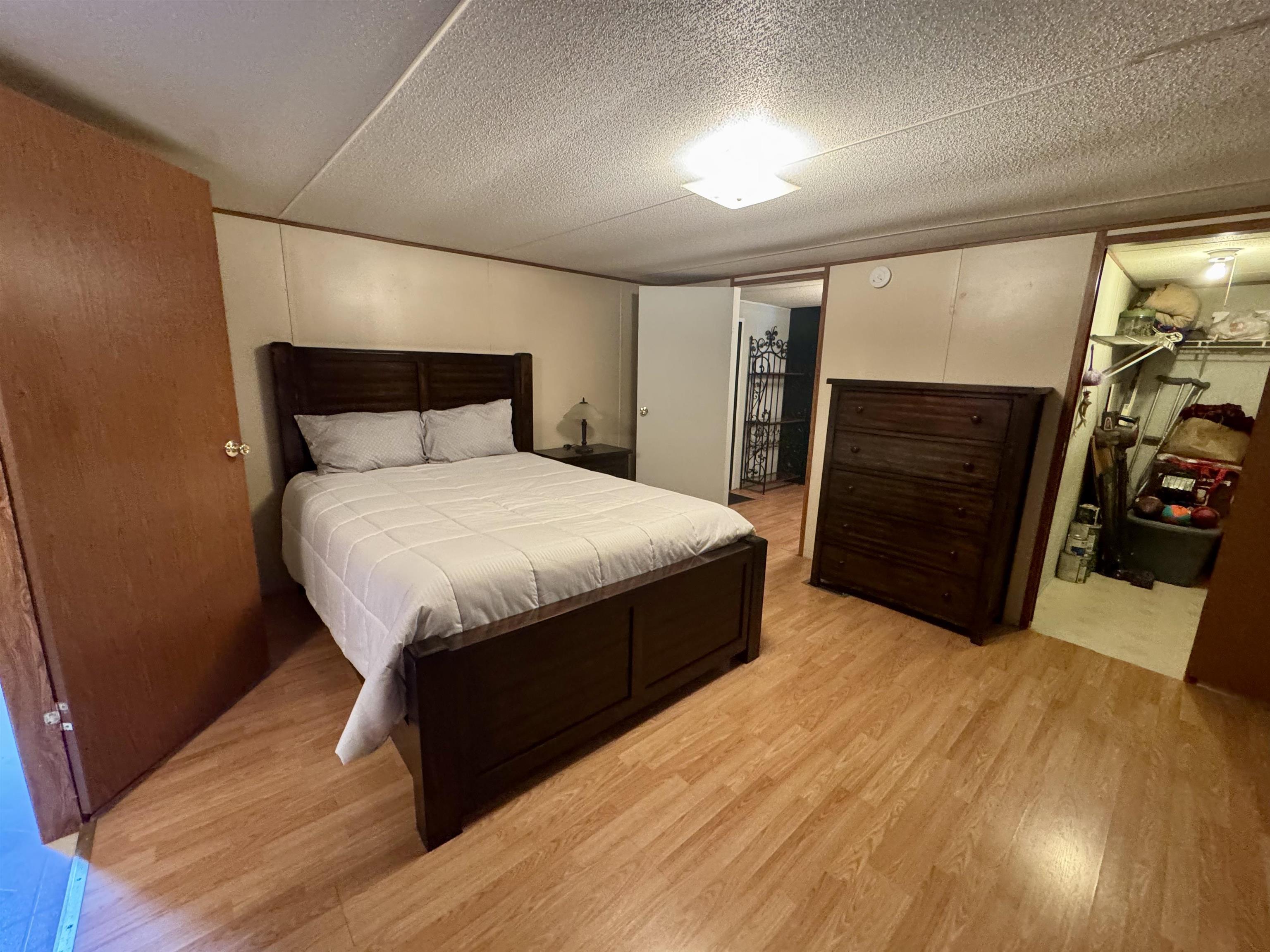 2511 Watkins Road Michie, TN 38357 - Photo 15 of 40 Room featuring light wood-finish flooring, light-toned wall paneling, and a flush-mount ceiling light fixture