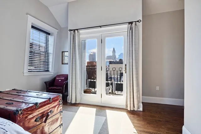 a room with furniture and two windows