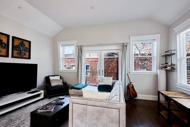 a view of a livingroom with workspace and a window