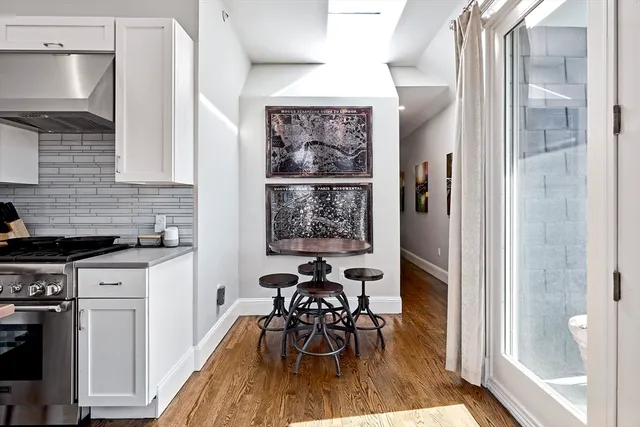 a view of a kitchen with a dining table chairs and entryway