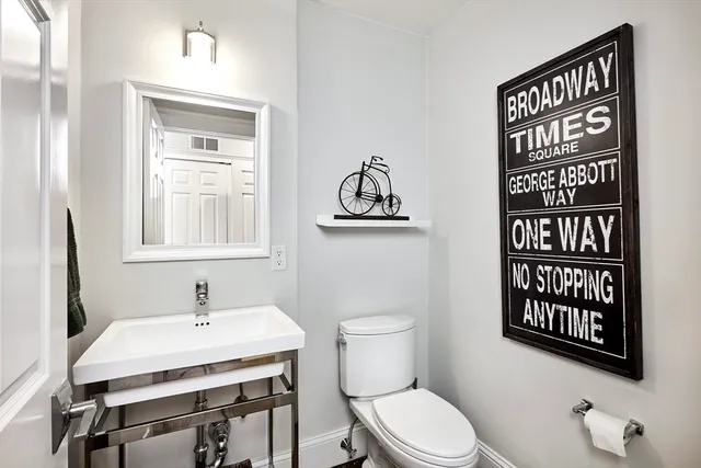 a bathroom with a toilet a sink and a window