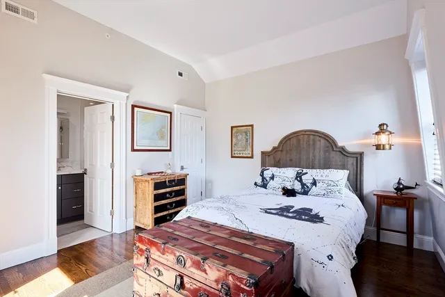 a bedroom with a bed and a dresser