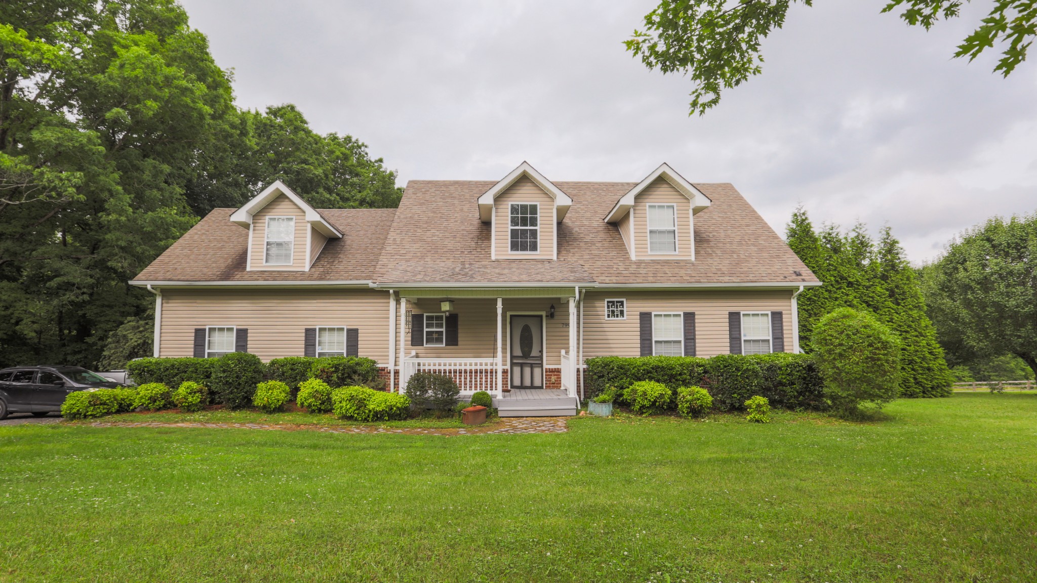 7993 Shoals Branch Road Primm Springs, TN 38476 - Photo 1 of 25 a front view of a house with a garden