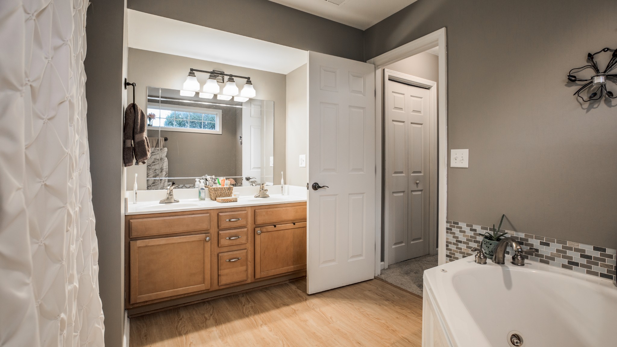 7993 Shoals Branch Road Primm Springs, TN 38476 - Photo 17 of 25 a bathroom with a tub sink and mirror