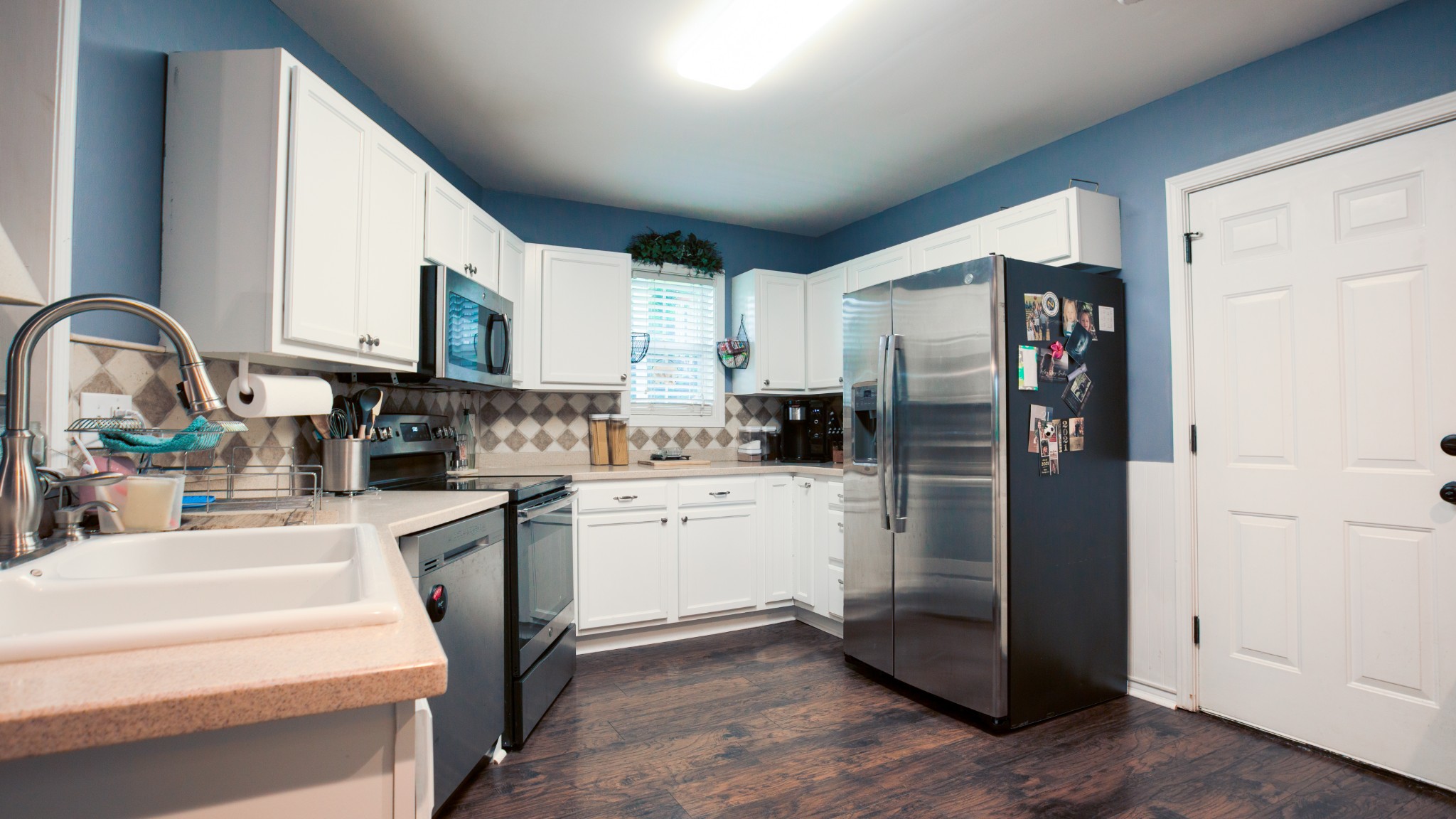 7993 Shoals Branch Road Primm Springs, TN 38476 - Photo 4 of 25 a kitchen with stainless steel appliances a refrigerator sink and cabinets