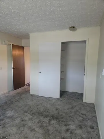 an empty room with closet area