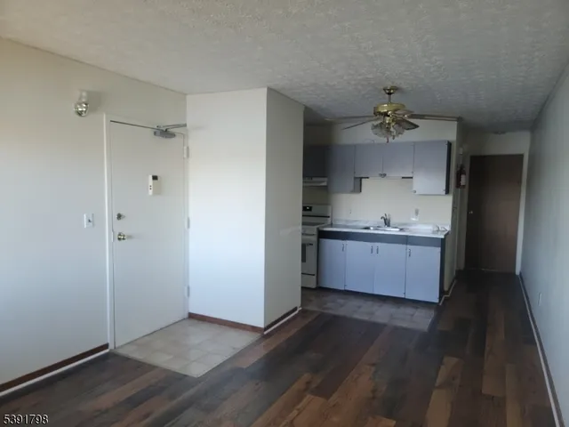 a view of kitchen with wooden floor and electronic appliances